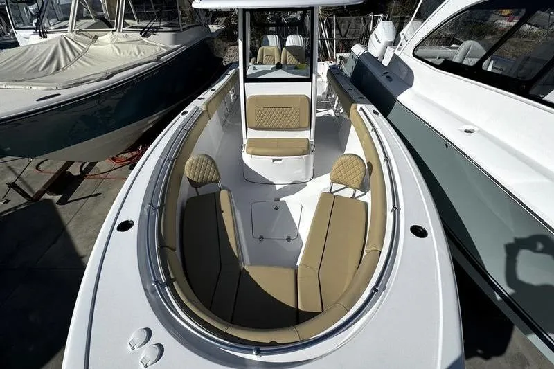 Slide: The Image of 2026 Sportsman Open 252 Center Console boat with tan seating and sleek design. - 11