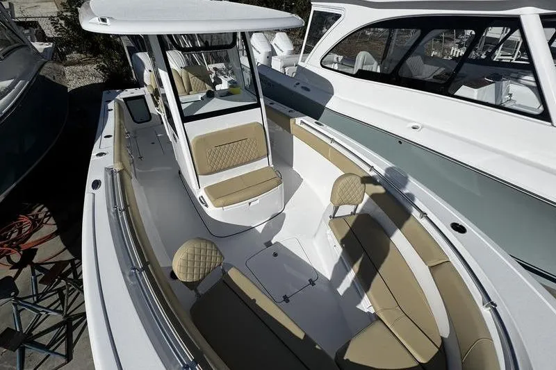 Slide: The Image of 2026 Sportsman Open 252 Center Console boat with tan seating and sleek design. - 12
