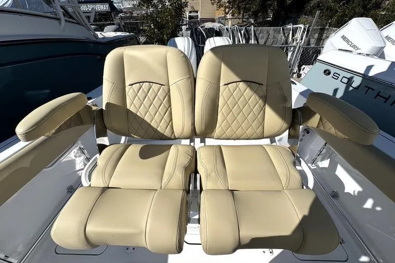 Slide: The Image of 2026 Sportsman Open 252 Center Console boat with beige leather seats. - 19
