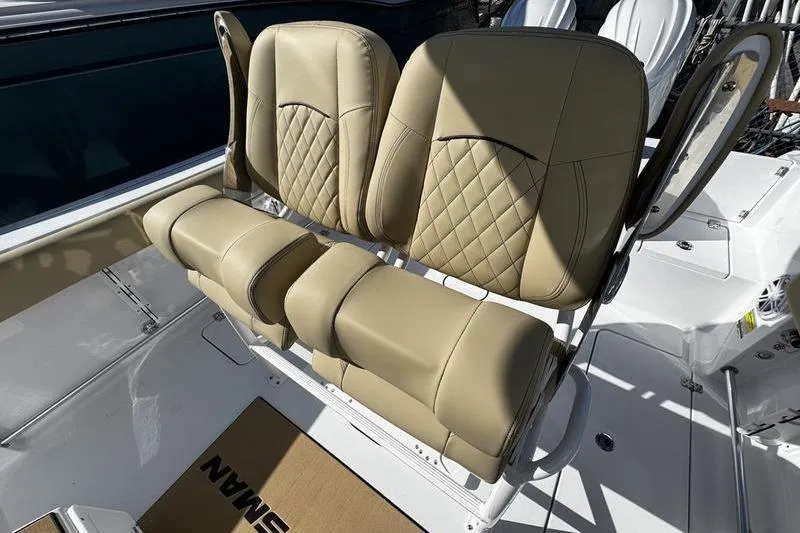 Slide: The Image of 2026 Sportsman Open 252 Center Console boat with tan leather seating. - 20