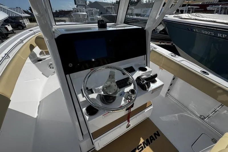 Slide: The Image of 2026 Sportsman Open 252 Center Console boat interior with steering wheel and controls. - 21