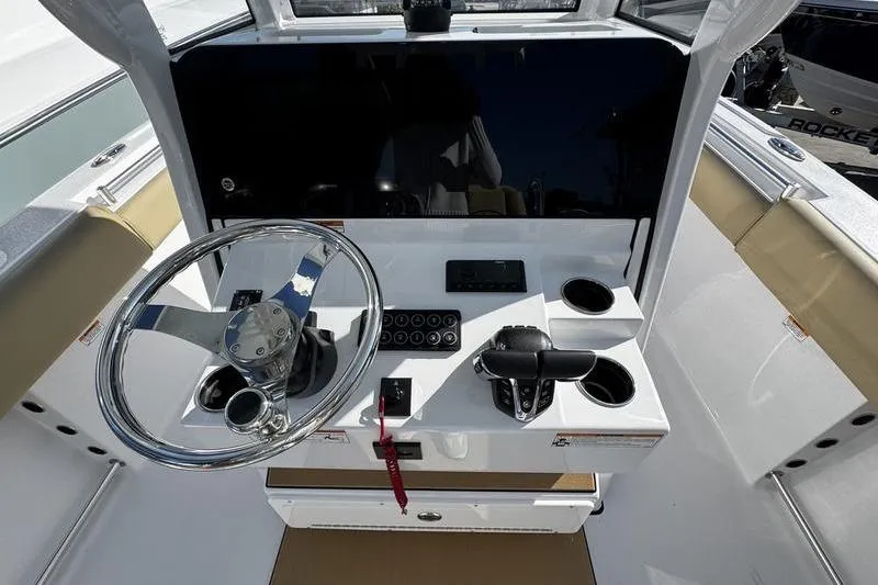 Slide: The Image of 2026 Sportsman Open 252 Center Console helm with steering wheel and controls. - 22