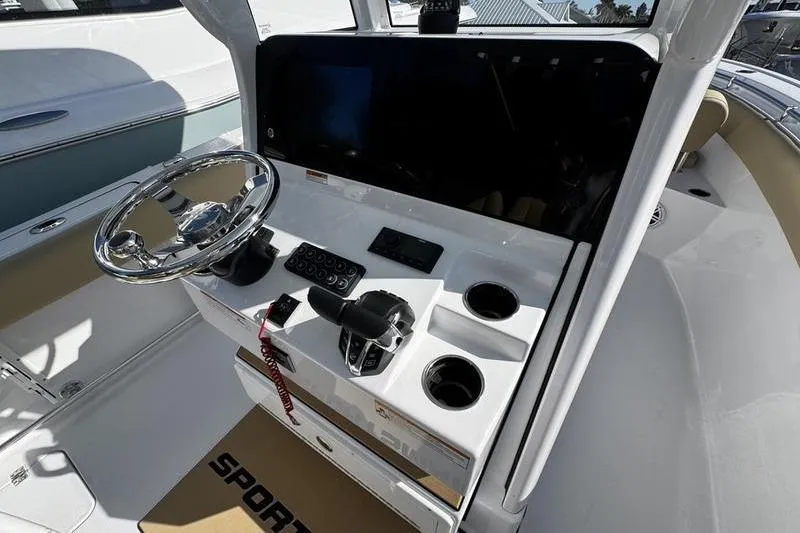 Slide: The Image of 2026 Sportsman Open 252 Center Console boat dashboard with steering wheel and controls. - 23