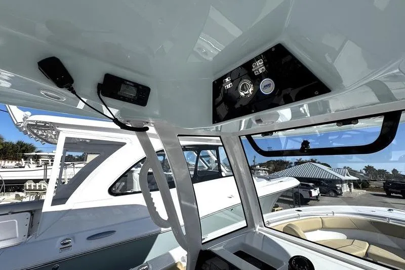 Slide: The Image of 2026 Sportsman Open 252 Center Console boat interior with modern controls and seating. - 24