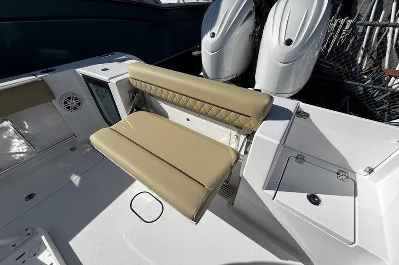 Slide: The Image of 2026 Sportsman Open 252 Center Console boat with tan seating and dual engines. - 26