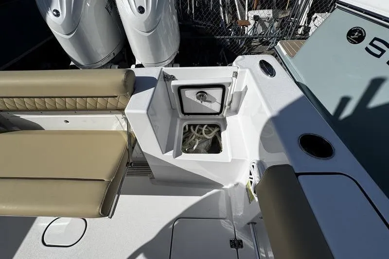 Slide: The Image of 2026 Sportsman Open 252 Center Console boat interior with seating and storage compartment. - 27