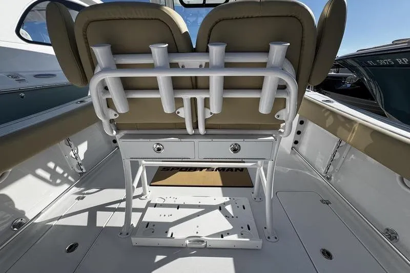 Slide: The Image of 2026 Sportsman Open 252 Center Console boat interior with rod holders and seating. - 28