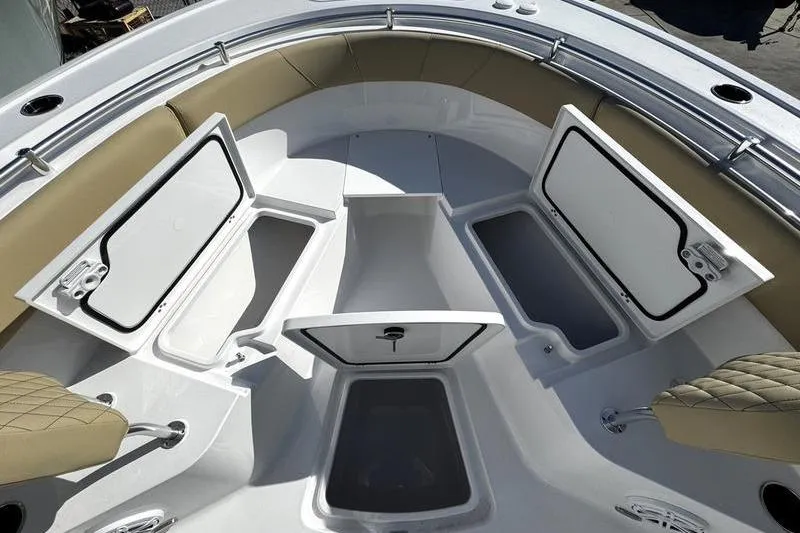 Slide: The Image of 2026 Sportsman Open 252 Center Console boat with open storage compartments and cushioned seating. - 7