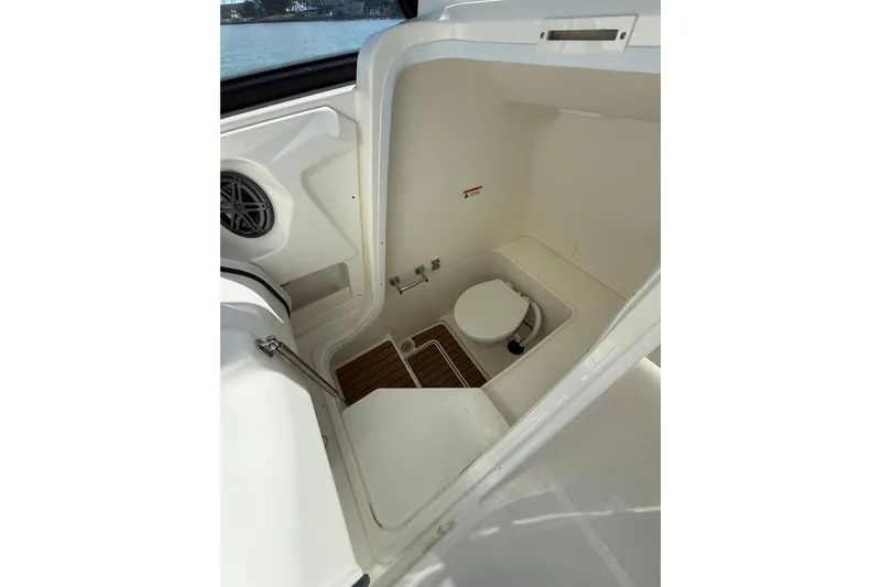 Slide: The Image of 2025 World Cat 260 DC-X boat interior with compact marine toilet. - 13