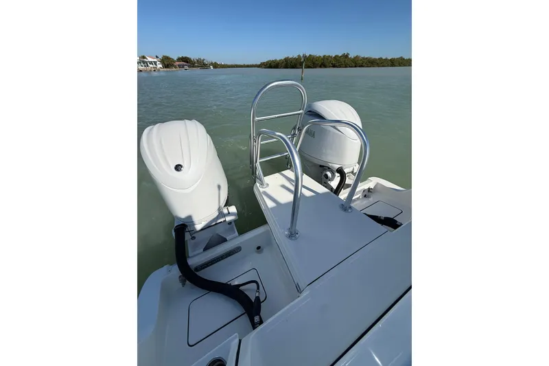 Slide: The Image of 2025 World Cat 260 DC-X boat with dual outboard motors on calm water. - 15