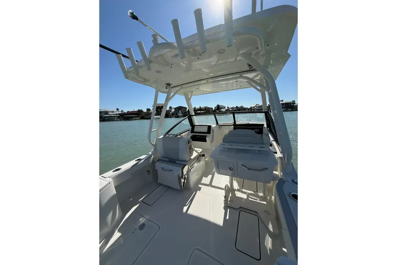 Slide: The Image of 2025 World Cat 260 DC-X boat interior with seating and fishing rod holders. - 2