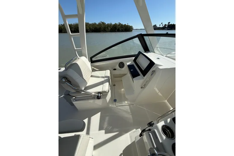 Slide: The Image of 2025 World Cat 260 DC-X boat interior with helm, seating, and water view. - 5