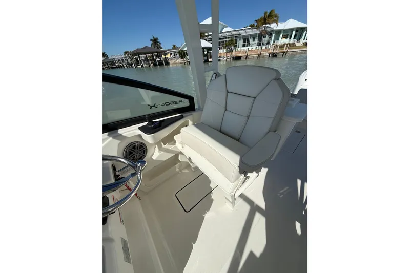 Slide: The Image of 2025 World Cat 260 DC-X boat interior with plush seating and steering wheel. - 6