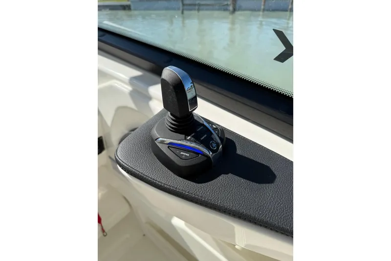 Slide: The Image of Joystick control on 2025 World Cat 260 DC-X boat dashboard, near water. - 7