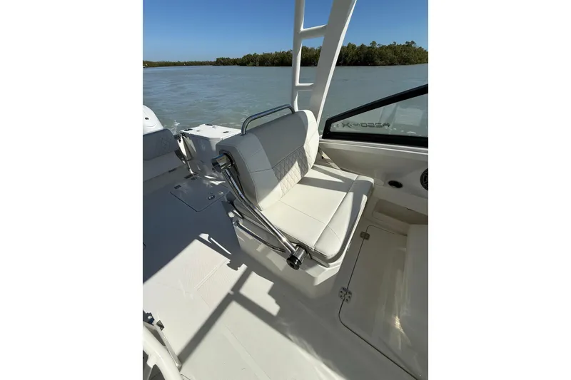Slide: The Image of 2025 World Cat 260 DC-X boat interior with white seating and scenic water view. - 8