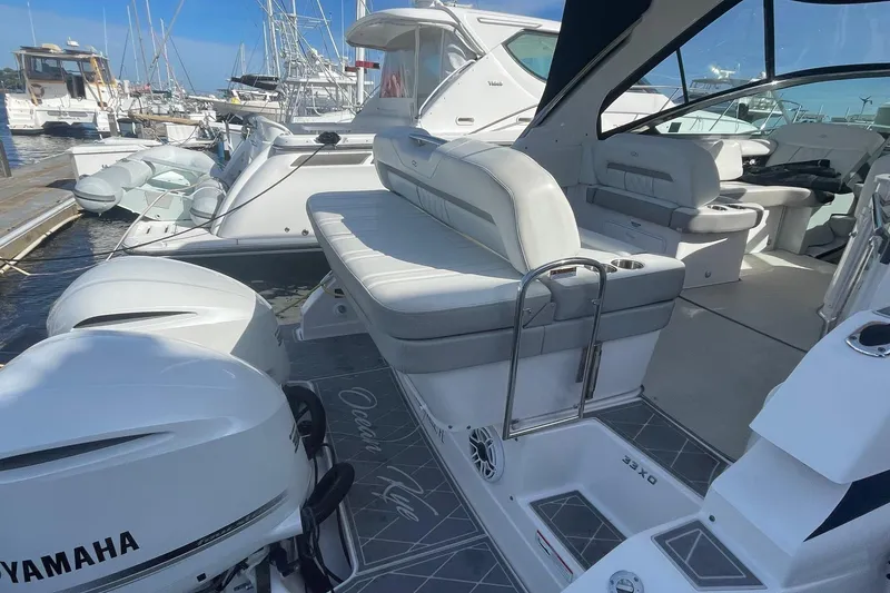 Slide: The Image of 2021 Regal 33 XO boat interior with Yamaha engines at marina. - 12