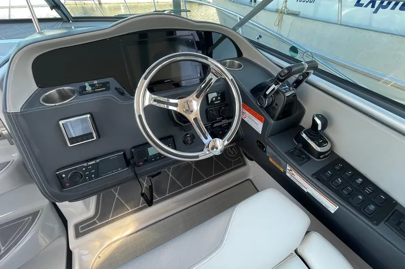 Slide: The Image of 2021 Regal 33 XO boat helm with modern controls and steering wheel. - 13
