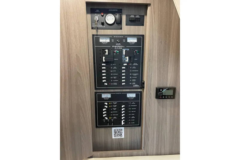 Slide: The Image of Control panel of a 2021 Regal 33 XO boat with various switches and gauges. - 27