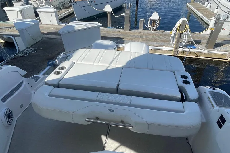 Slide: The Image of 2021 Regal 33 XO boat with white seating at a marina dock. - 5