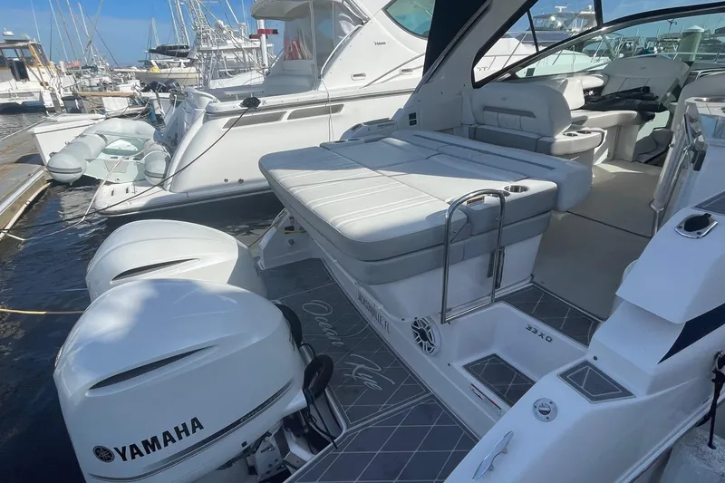Slide: The Image of 2021 Regal 33 XO boat with Yamaha engines docked at marina. - 6
