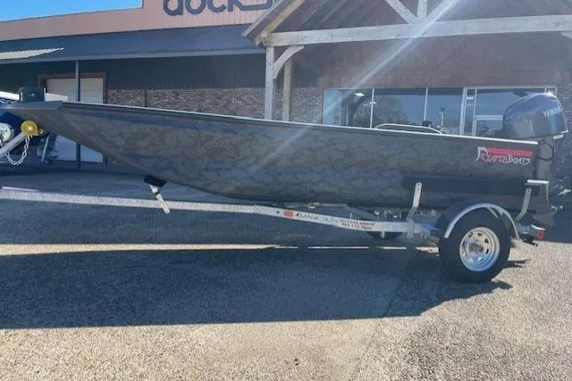 Slide: The Image of 2026 Reaper Boats 656-1882 model on trailer, parked outside a building. - 5