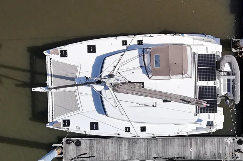 Slide: The Image of Aerial view of 2016 Fountaine Pajot Lucia 40 catamaran docked, featuring solar panels and spacious deck. - 100