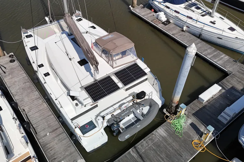 Slide: The Image of 2016 Fountaine Pajot Lucia 40 catamaran docked with solar panels and dinghy. - 101