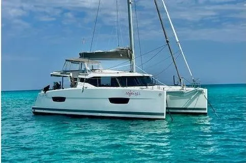 Slide: The Image of 2016 Fountaine Pajot Lucia 40 catamaran sailing on turquoise waters under a blue sky. - 103