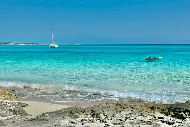 Slide: The Image of Sailboat Fountaine Pajot Lucia 40, 2016, anchored in clear turquoise waters near rocky shore. - 15