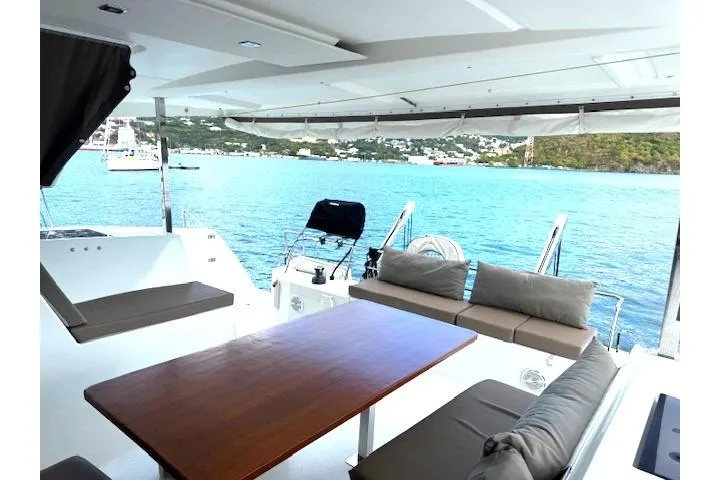 Slide: The Image of Spacious deck of 2016 Fountaine Pajot Lucia 40 catamaran with scenic ocean view. - 2