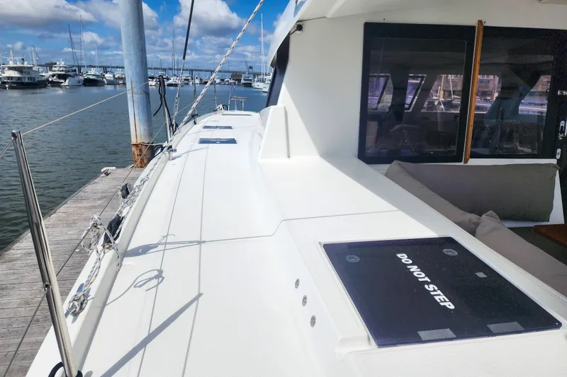 Slide: The Image of 2016 Fountaine Pajot Lucia 40 yacht cockpit view with winches and marina backdrop. - 28