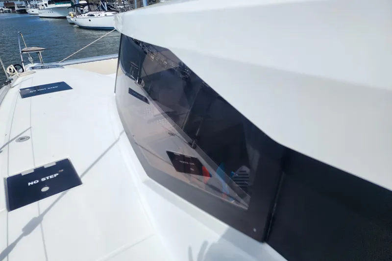 Slide: The Image of 2016 Fountaine Pajot Lucia 40 catamaran deck with seating and marina view. - 31