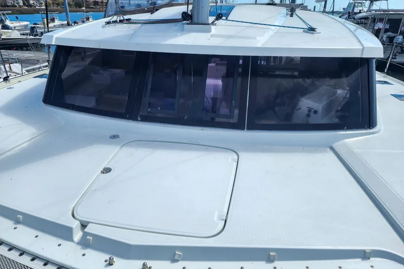 Slide: The Image of 2016 Fountaine Pajot Lucia 40 catamaran docked at marina, featuring spacious deck and netting. - 37