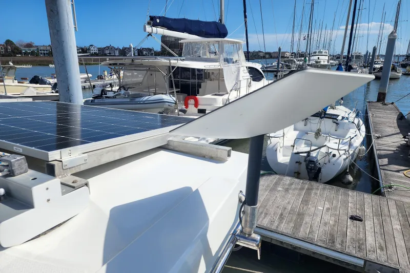 Slide: The Image of 2016 Fountaine Pajot Lucia 40 yacht deck with "Do Not Step" sign, docked by water. - 39
