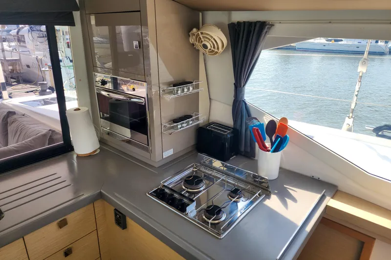 Slide: The Image of Luxurious interior of 2016 Fountaine Pajot Lucia 40 catamaran with beige seating and striped pillow. - 47