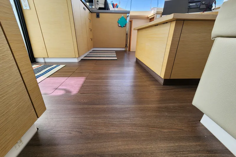 Slide: The Image of Interior hallway of 2016 Fountaine Pajot Lucia 40 catamaran, featuring modern wood paneling. - 62