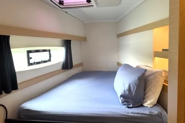 Slide: The Image of Cabin interior of 2016 Fountaine Pajot Lucia 40 with cozy bed and storage shelves. - 68