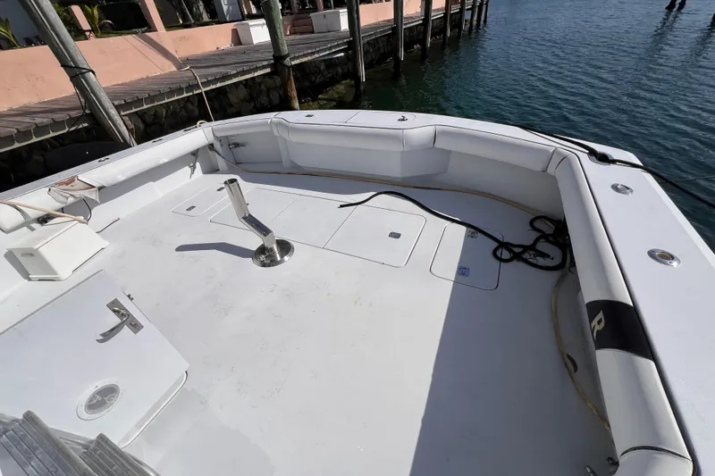 Slide: The Image of Spacious deck of 2001 Hatteras 65 Convertible yacht, docked by the water. - 10