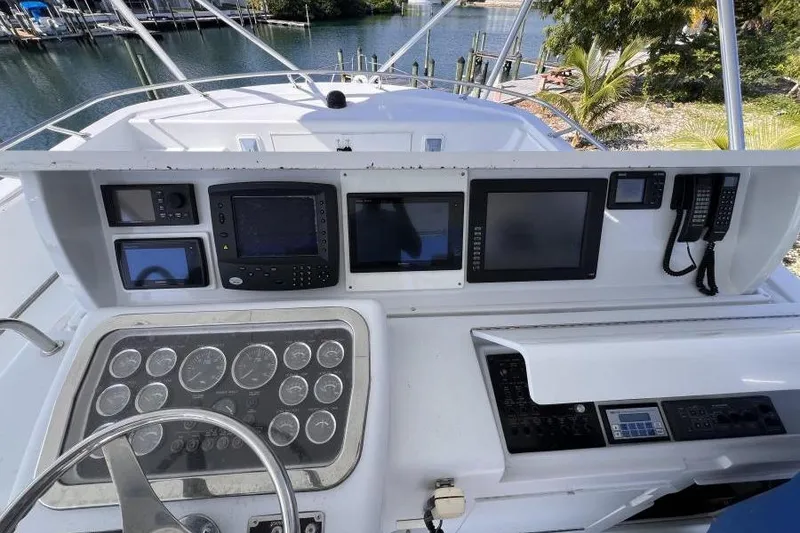 Slide: The Image of Helm of 2001 Hatteras 65 Convertible yacht with navigation instruments and controls. - 13