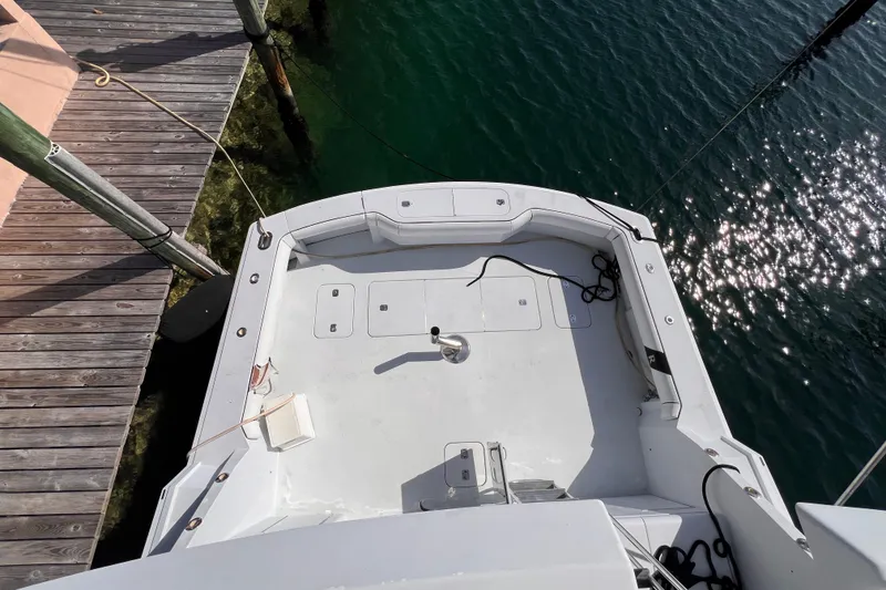 Slide: The Image of Aerial view of 2001 Hatteras 65 Convertible yacht deck by the water. - 18