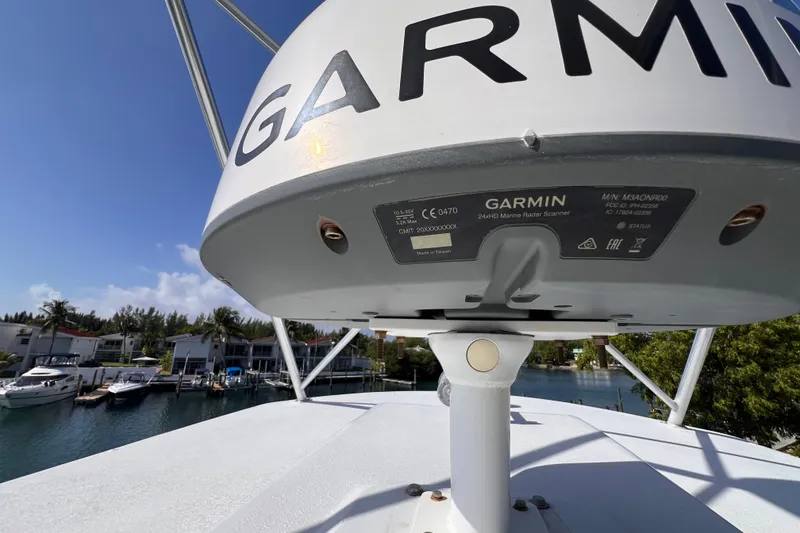 Slide: The Image of Garmin radar on 2001 Hatteras 65 Convertible yacht, docked near waterfront homes. - 30