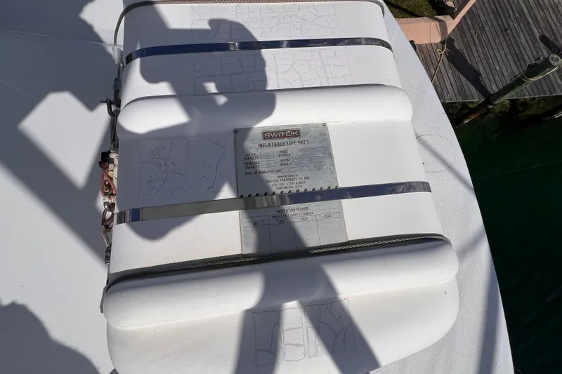 Slide: The Image of Inflatable life raft on 2001 Hatteras 65 Convertible yacht deck, secured with straps. - 31