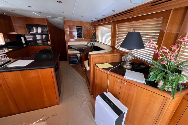 Slide: The Image of Luxurious interior of 2001 Hatteras 65 Convertible yacht with elegant wood finishes. - 38