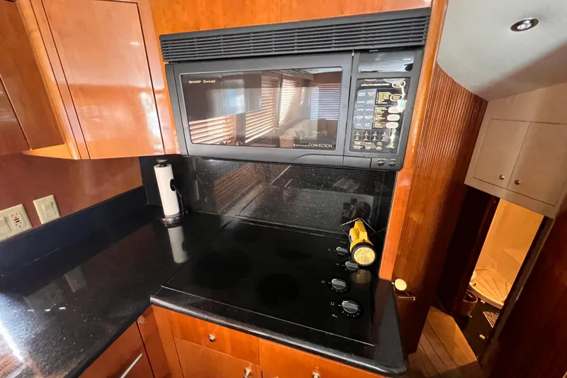 Slide: The Image of Kitchen area of 2001 Hatteras 65 Convertible yacht with stove and microwave. - 42