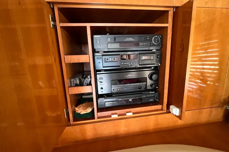 Slide: The Image of Audio equipment cabinet on 2001 Hatteras 65 Convertible yacht, featuring Sony stereo system. - 45