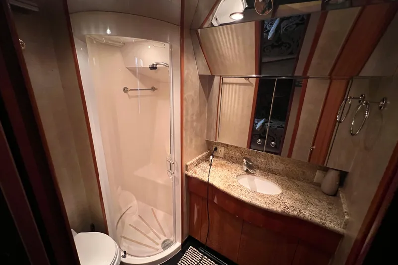 Slide: The Image of Luxurious bathroom in 2001 Hatteras 65 Convertible yacht with shower and granite countertop. - 46