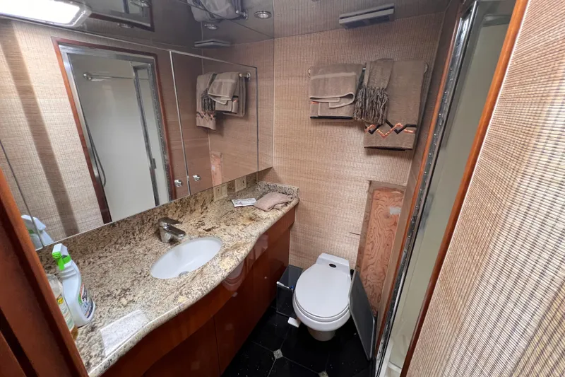 Slide: The Image of Luxurious bathroom in 2001 Hatteras 65 Convertible yacht with granite countertop and modern fixtures. - 49