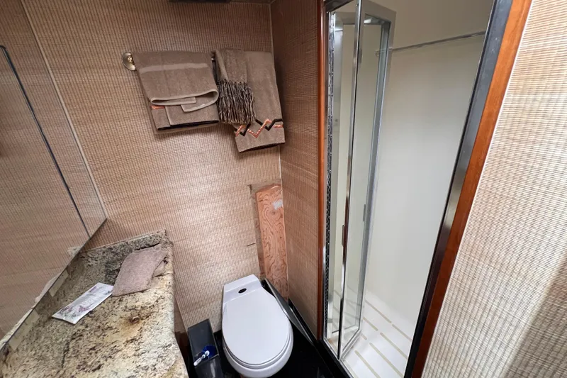 Slide: The Image of Luxurious bathroom in 2001 Hatteras 65 Convertible yacht with shower and granite countertop. - 50