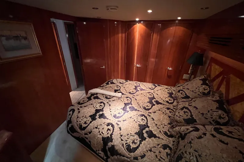 Slide: The Image of Luxurious bedroom interior of 2001 Hatteras 65 Convertible yacht with elegant bedding. - 51