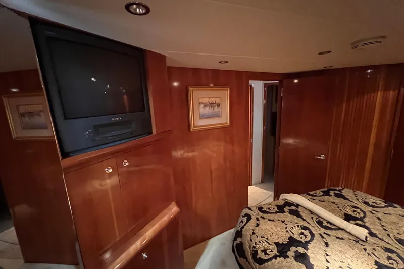 Slide: The Image of Luxurious interior of 2001 Hatteras 65 Convertible yacht with wood paneling and vintage TV. - 52